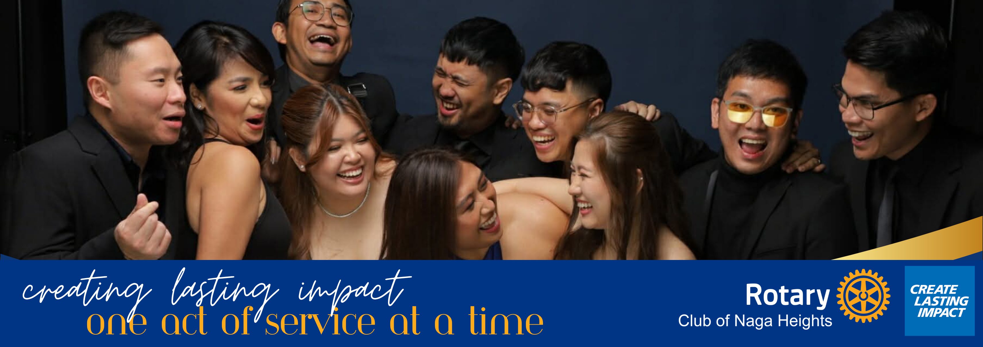 Rotary Club of Naga Heights members laughing together at a club gathering, with the club's Create Lasting Impact theme banner.